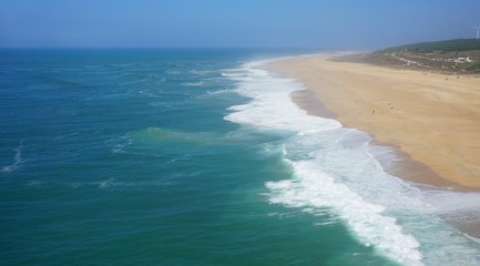 rough waves touching coast at nazare in portugal