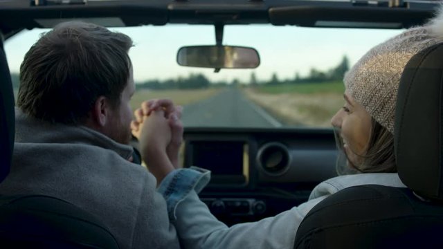 Cute Couple Go For A Drive On Sunny Autumn Day In Country, They Hold Hands, Man Kisses His Wife's Hand, Slow Motion