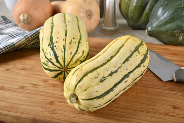 Delicata and other winter squash on a cutting board