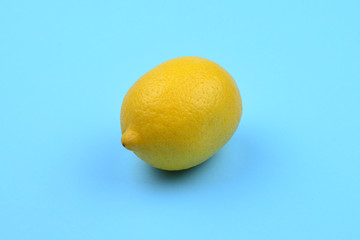 Lemon isolated on blue background. Space for test or design.