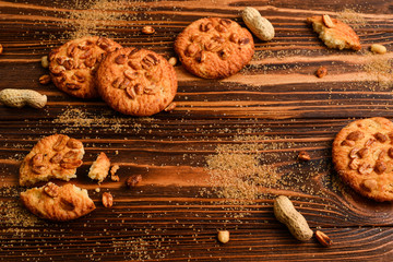 Peanut cookies on wooden table with sugar.