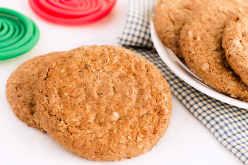 Homemade shortbread cookies made of oatmeal are stacked in plate on cloth on white table background. Food snack for enjoy in holiday concept. with copy space for text.