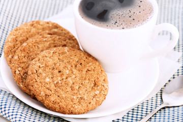 Homemade shortbread cookies made of oatmeal are stacked with hot coffee cup on white table background. Food snack for breakfast concept. with copy space for text.