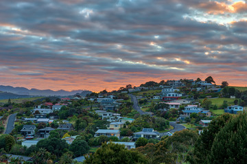 colorful sunrise over mangonui town in New Zealand