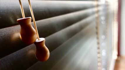 Dirty in dust spots horizontal on window wooden blinds close-up. not good for healthy, should to clean it every week.                             