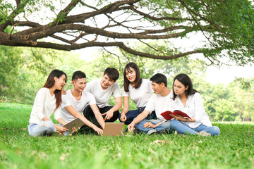 Asian student relax with friend in park
