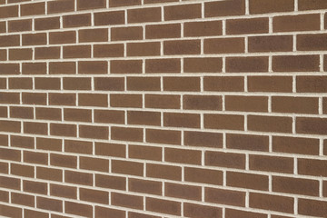 Fototapeta premium Vintage brown color brick wall background in traditional running bond pattern (angle view)