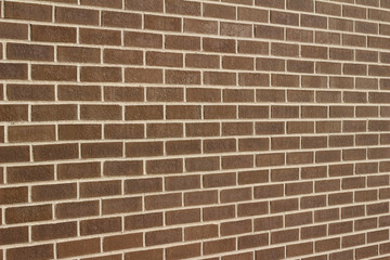 Fototapeta premium Vintage brązowy kolor tła ściany z cegły w tradycyjnym wzorze bieżącej obligacji (widok pod kątem)