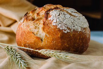 Mediterranean bread called pan de payes or pa de pages on a rustic background.  Spanish round bread typical from Catalonia