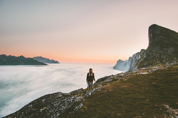 Naklejka na ściany i meble Active woman hiking in mountains outdoor active vacations traveling alone adventure healthy lifestyle girl trail running above clouds on ridge