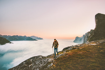 Fototapeta premium Active man trail running in sunset mountains with backpack Traveling heathy lifestyle adventure concept hiking alone vacations outdoor journey in Norway