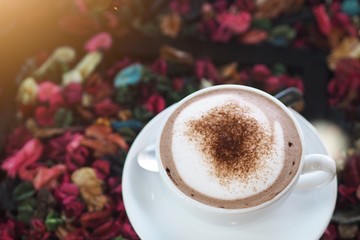 Sweet hot coco cup on vintage dried flora table in early morning to increase your energy 