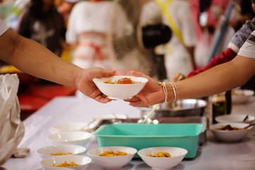 The hands of beggars offer food from the donor : The life of the poor