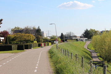 Naklejka premium Dyke along river Hollandsche IJssel at village Ver-Hitland, part of Zuidplas