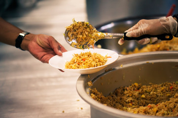The hands of beggars offer food from the donor : The life of the poor