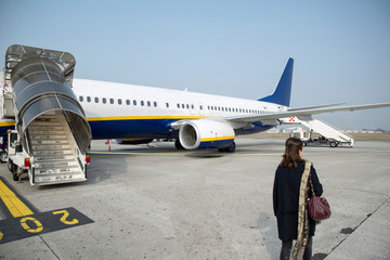 Girl ready to board on the plane and fly to a warm destination