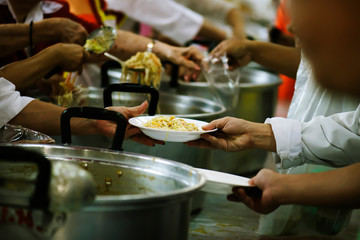 Volunteers Share Food to the Poor to Relieve Hunger: Charity concept