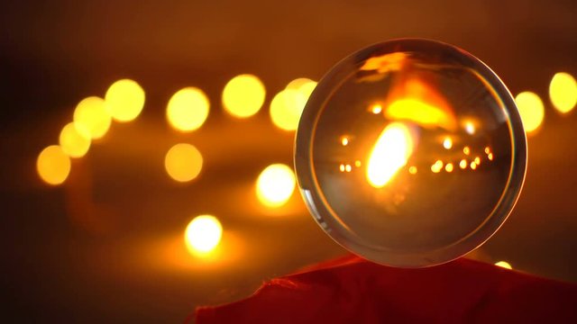 Closeup shot of a candle inside a crystal ball
