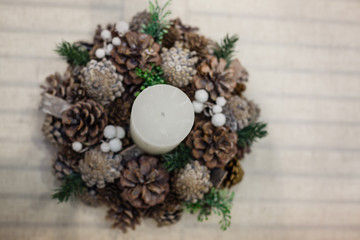 Christmas decor, advent wreath with a candle, vertical photo