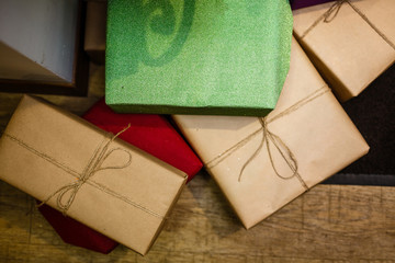 Brown, green, and red wrapped giftboxes, top view