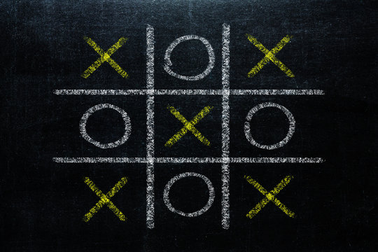 Abstract Tic Tac Toe Game Competition. XO Win Challenge Concept on black board