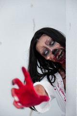 Portrait of asian woman make up ghost face with blood on white background,Horror scene,Scary...