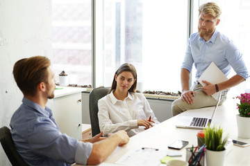 Group of young business people and designers. They working on new project.