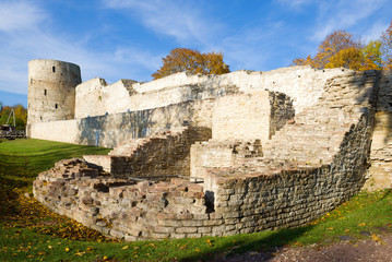 At the walls of the Izborsk fortress on a sunny October day. Old Izborsk, Russia