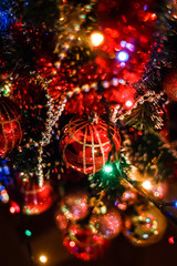 Christmas tree decorated with lights and baubles, vertical photo
