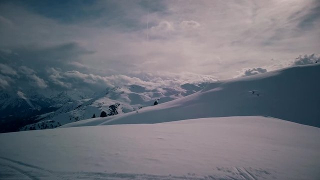 Aerial view on a man standing on top of mountain and drone is flying away from him. Scenic panorama of valley appears. Zillertal, Kaltenbach, Austria. 4K footage.