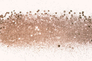 Rose gold glitter and glittering stars on white background in vintage colors