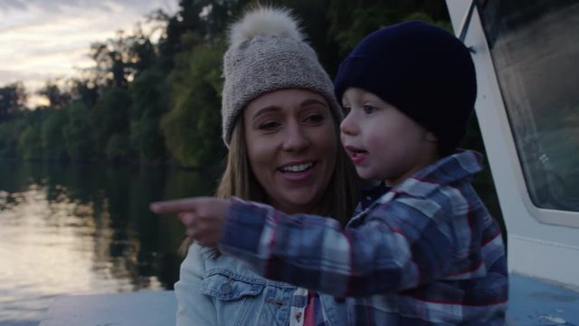 Closeup Of Happy Mom And Son Enjoying Views From Ferry, They Look And Point, Beautiful Sunset On Water, Slow Motion