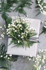Gift box decorated winter plants and flowers. Flat lay, top view. The concept of New Year and Christmas.