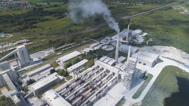 Cement factory, industrial enterprise. The smoking factory chimney.