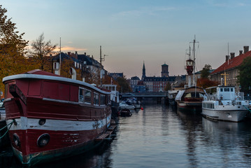 Sunset in Copenhagen on an old canal with boats and houses reflecting in the calm waters - 2