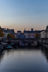 Fototapeta premium Sunset in Copenhagen on an old canal with boats and houses reflecting in the calm waters - 4