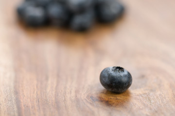 Ripe blueberries on wood background