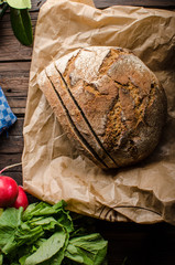 Homemade bread with fresh creame, herbs and radishes