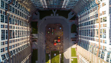 Bird-eye view of the playground kids in a residential complex in sunny  day