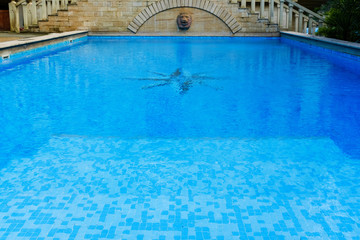 Fototapeta na wymiar surface of blue swimming pool,background of water in swimming pool.