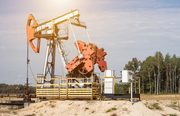 Oil well for the extraction of oil and gasoline and gas on the background of the forest, the...
