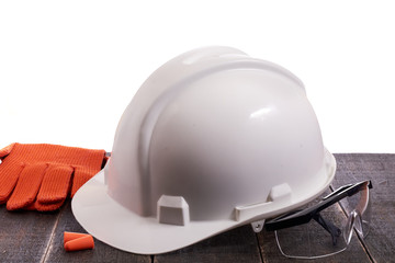 Fototapeta premium Safety personal protective euipment on a black wooden table on a white isolated background