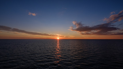 Fototapeta na wymiar colorful dramatic sunrise in the sea. view from ferry