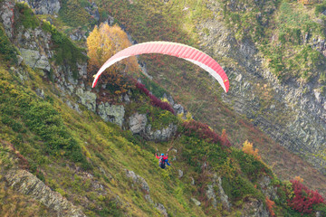 Paragliders fly in the mountains, landscape