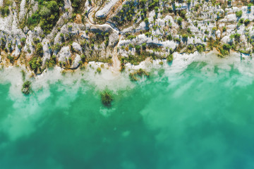 Inactive gypsum quarry. In the quarry is a lake with blue water