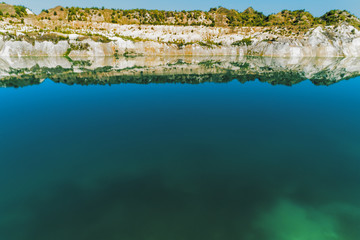 Inactive gypsum quarry. In the quarry is a lake with blue water