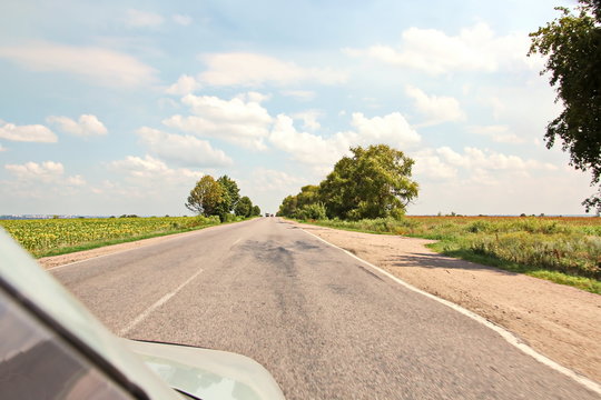 Landscape views of nature, fields, villages and roads of Ukraine. View from the car window when driving.
