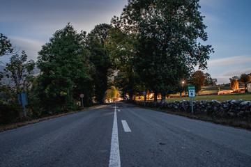 road in the mountains at night with a dark night sky