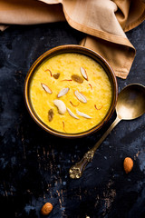 Kaddu or Pumpkin Kheer Or Bhoplyachi Kheer in Marathi and gummadikaya payasam in Telugu, Garnished with dry fruits. served in a bowl over moody background. Selective focus