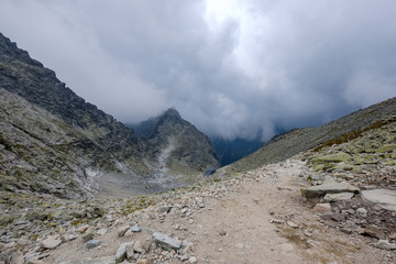 peak of Rysy mountain covered in mist. autumn ascent on hiking trails